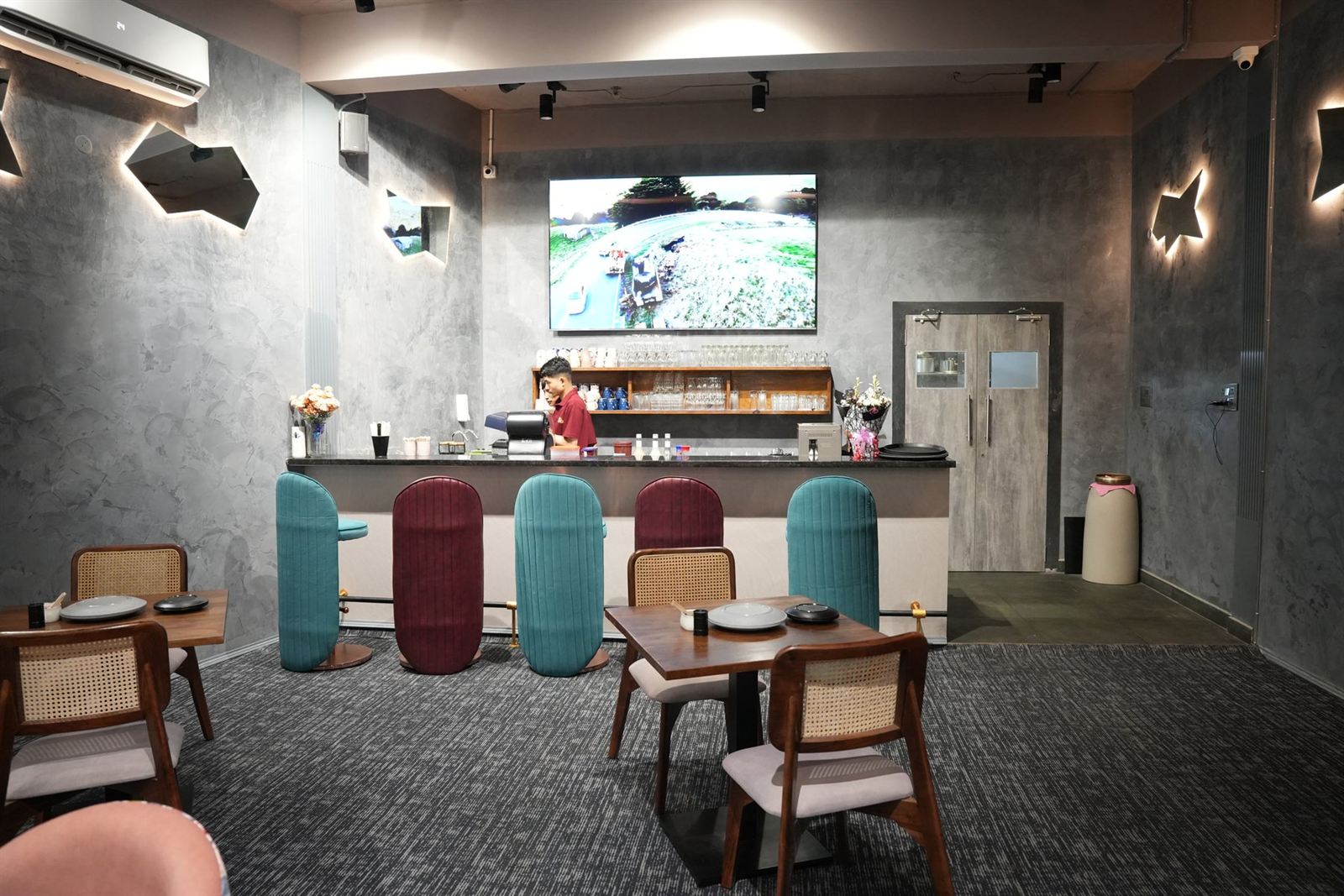 Full showroom floor with three bikes on display platform